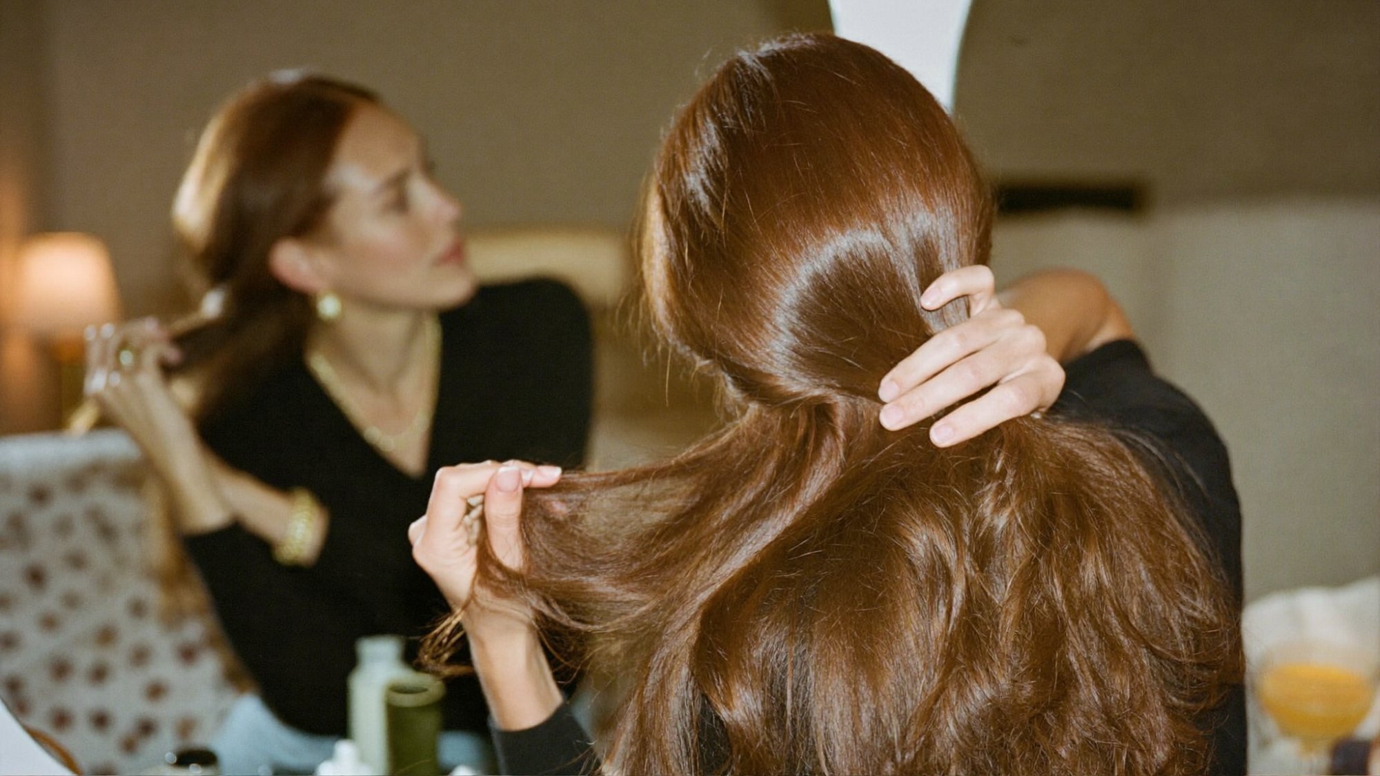 Stylist blending a European Remy hair topper into a client’s hair at Studio T Salon in Crystal Lake