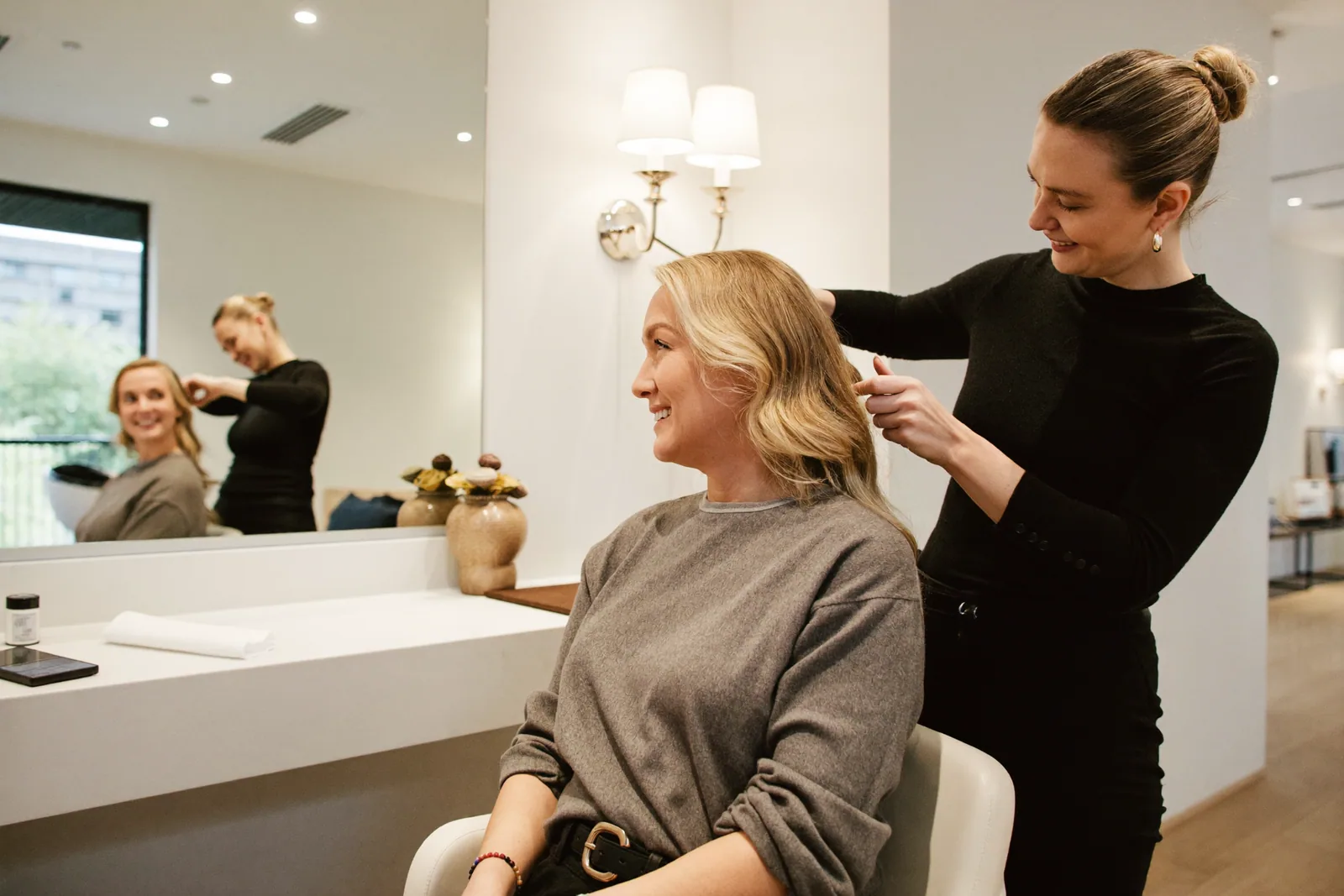 Studio T Salon stylist fitting a hair topper on a client