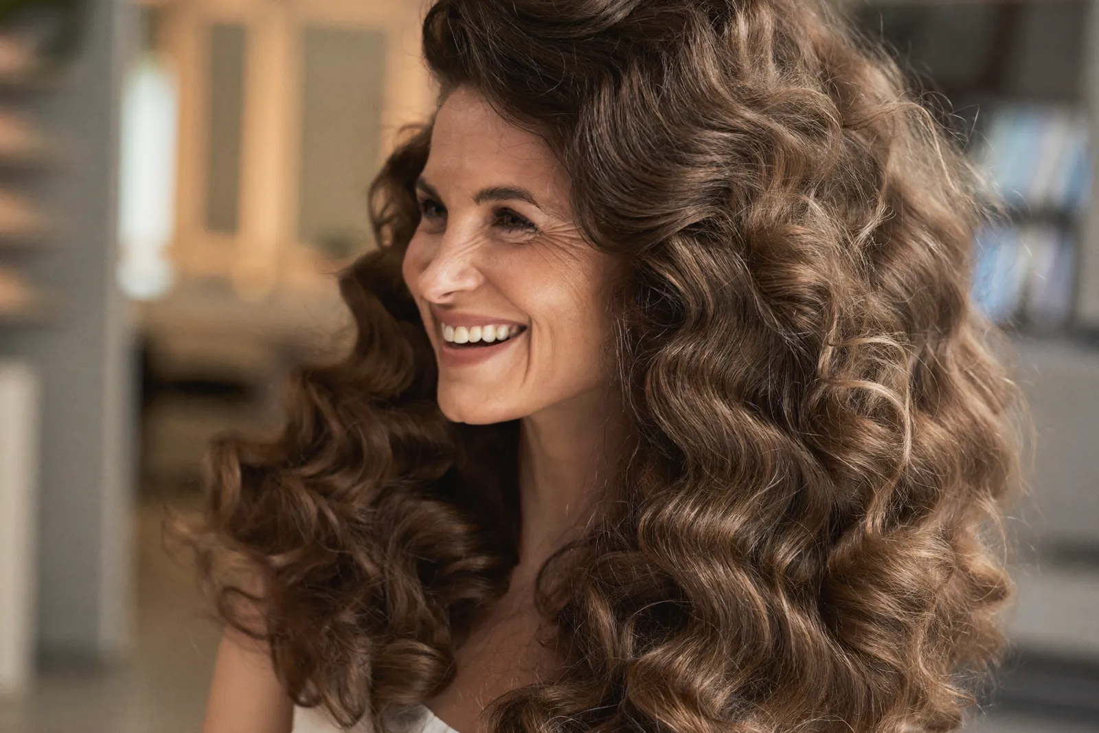 Smiling woman with voluminous curly hair