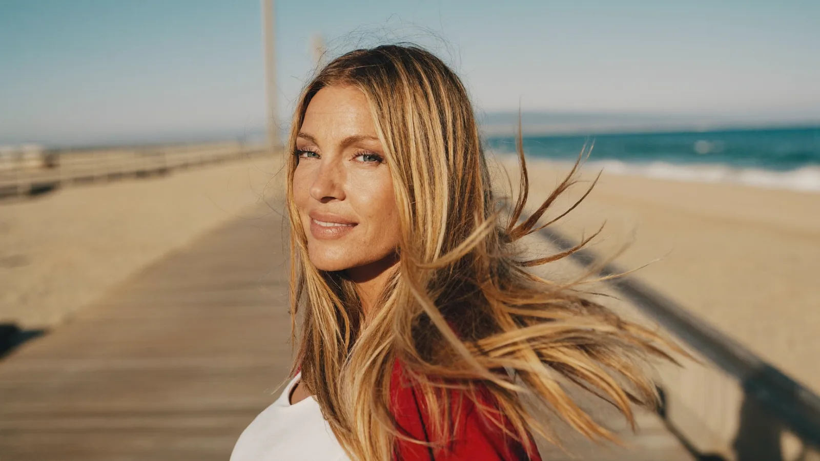 Woman with long hair on a beach boardwalk
