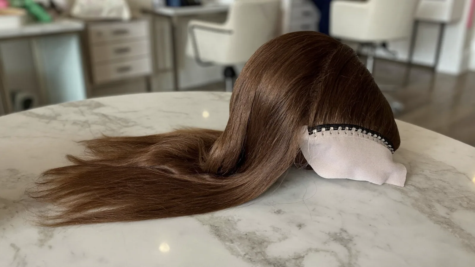 Woman with healthy, styled hair from a well-cared-for topper