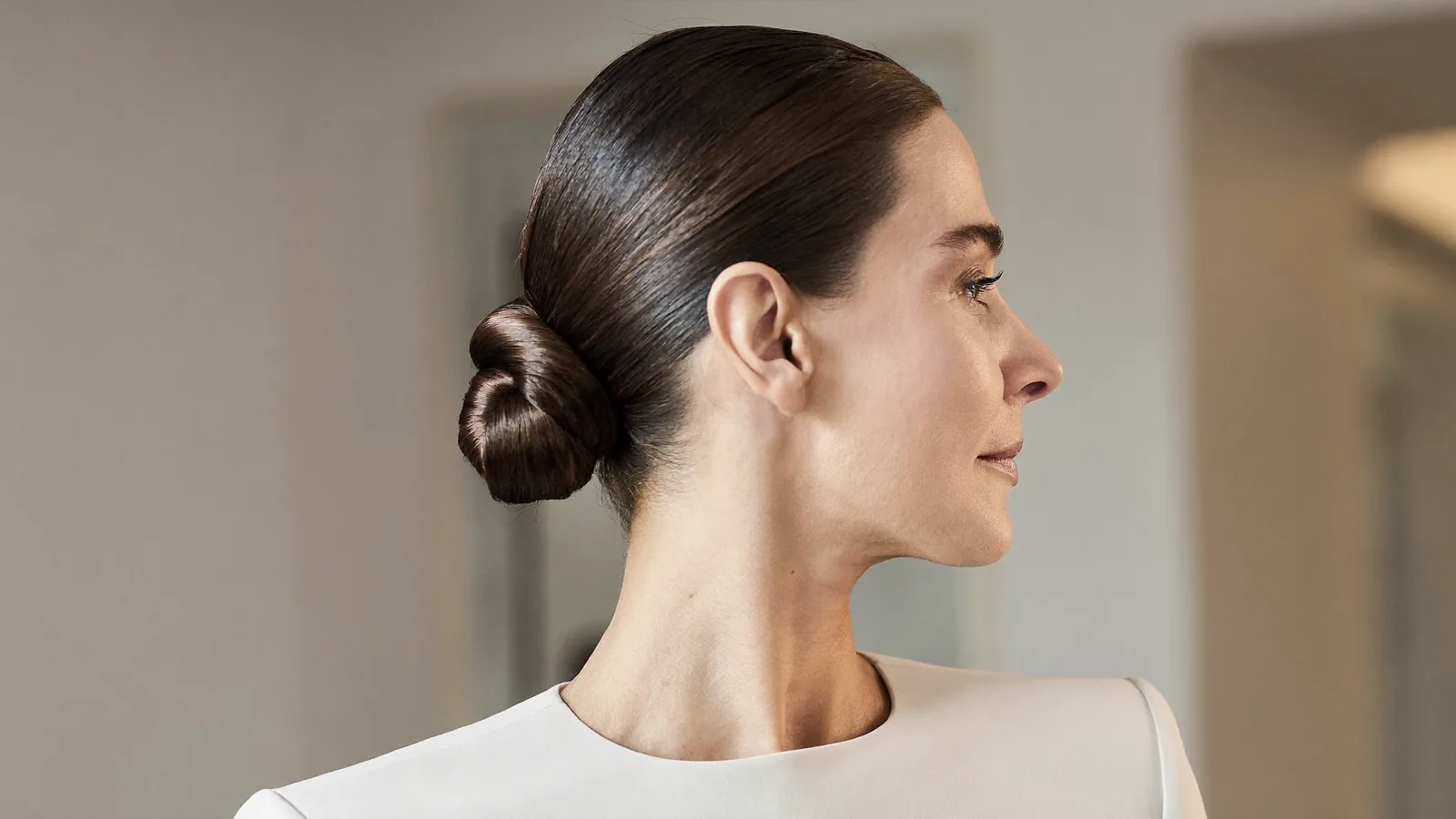 Woman with hair in a tight low bun