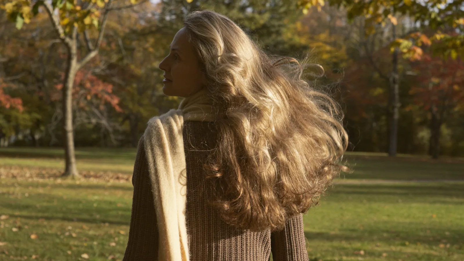 Woman with long hair walking in a park